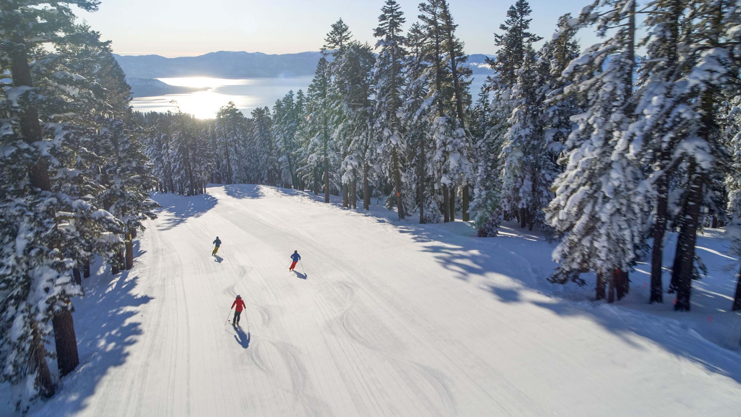 Aerial Photo of Three People Skiing down East Ridge at Northstar