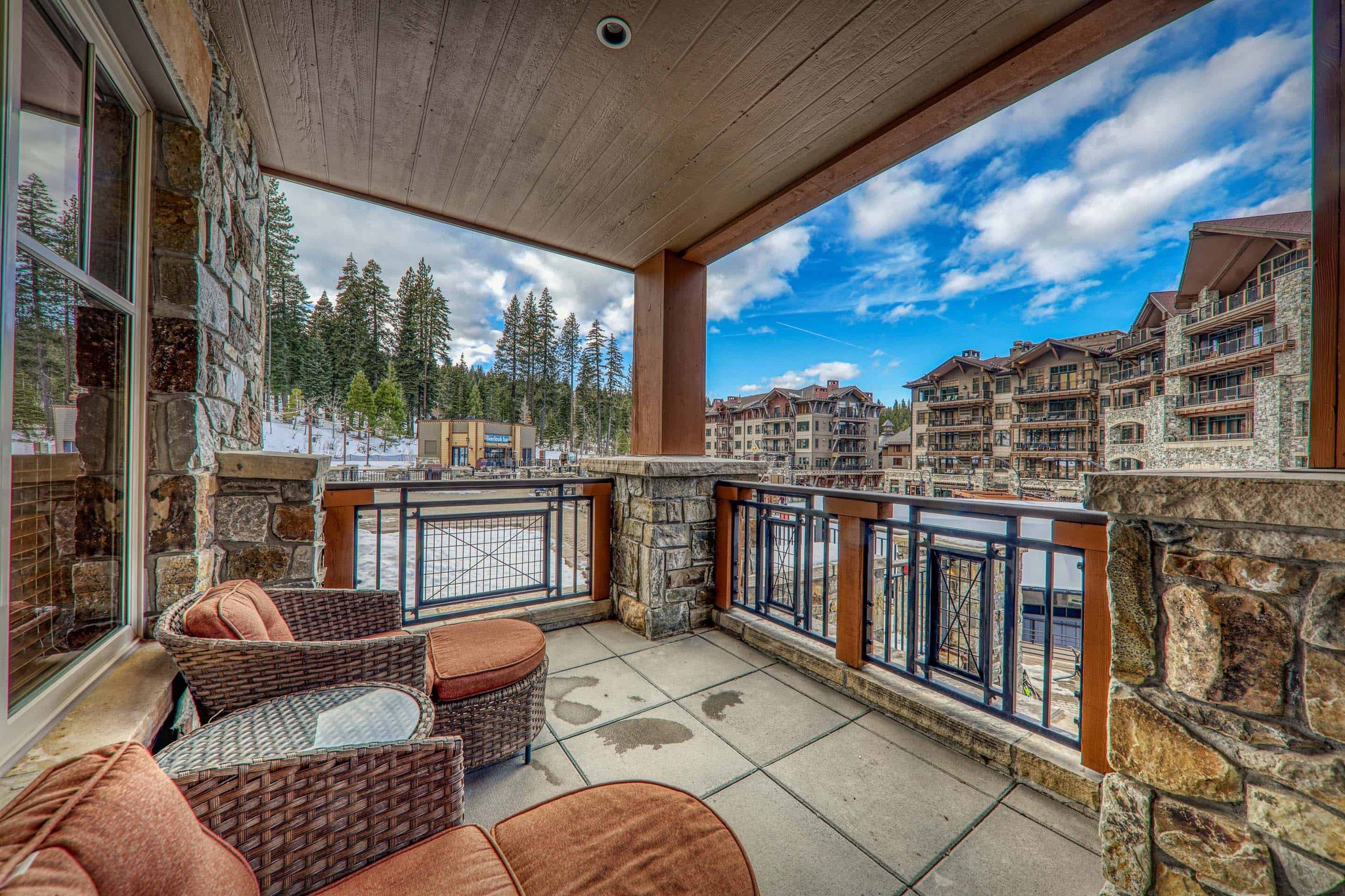 comfortable chairs on a balcony overlooking a mountain resort