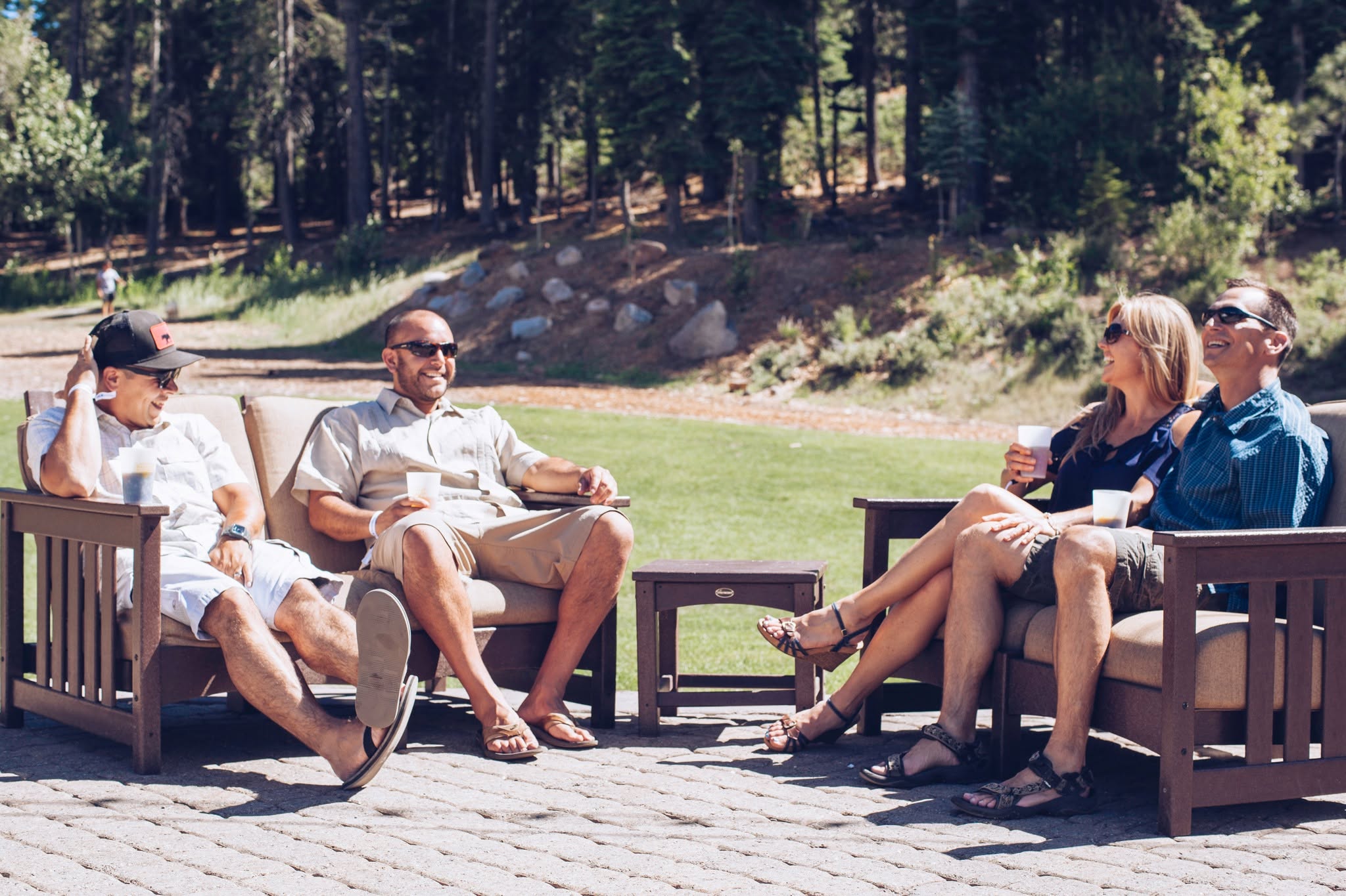 4 friends relaxing in chairs outdoors