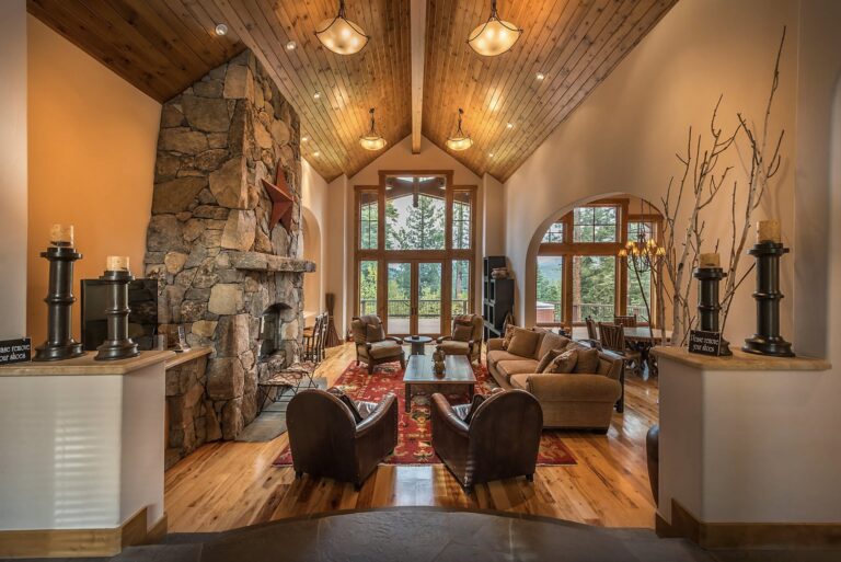 living room of a ski lodge with two chairs facing the window